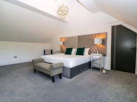 A bedroom with a bed and side tables at Thornbury, Barnard's Green, Malvern