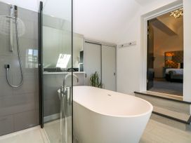 A bathroom with a bathtub and shower at Thornbury, Barnard's Green, Malvern