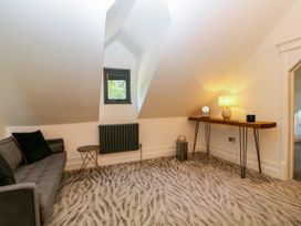 A living room with a sofa and a table at Thornbury, Barnard's Green, Malvern