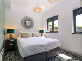 A bedroom with a bed and nightstand at Thornbury, Barnard's Green, Malvern