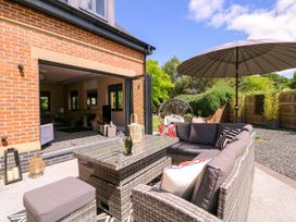 An outdoor seating area with furniture and plants at Thornbury, Barnard's Green, Malvern