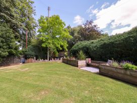 A garden with grass and trees at Thornbury in Barnard's Green, Malvern