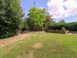 A garden with trees and grass at Thornbury, Barnard's Green, Malvern