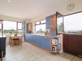 A kitchen with cabinets and a table at Ard na Gréine in Glenties, County Donegal