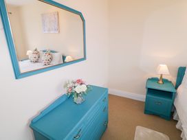 A bedroom with a mirror and decorative pillows at Ard na Gréine, Glenties, County Donegal