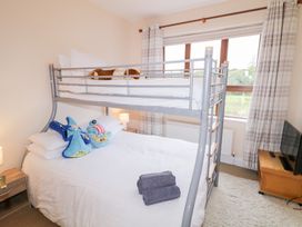 A bedroom with a bunk bed and a double bed at Ard na Gréine in Glenties, County Donegal