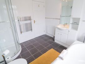 A bathroom with a shower, sink, and bathtub at Ard na Gréine, Glenties, County Donegal