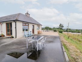 An outdoor area with a table and chairs at Ard na Gréine in Glenties, County Donegal