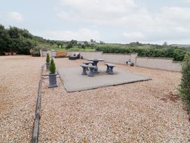 A garden with a gravel surface and seating area at Ard na Gréine, Glenties, County Donegal