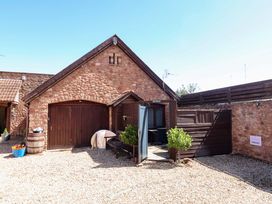 An outdoor view of a cottage entrance with garden features at The Retreat Washford near Williton