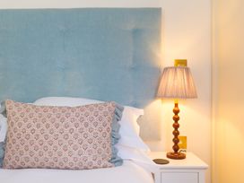 A bedroom with a bed and lamp at Scilly Stack in Penzance