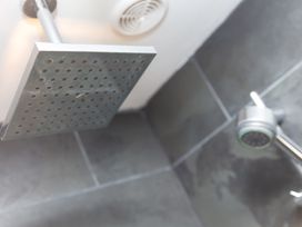 A shower configuration with a square shower head and nozzle at Scilly Stack in Penzance