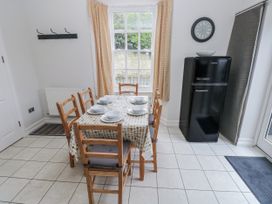 A dining room with a table and chairs at Crown Cottage in Penally