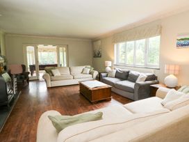 A living room with sofas and a coffee table at Tynewydd Fields in Cross Inn