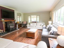 A living room with a sofa and coffee table at Tynewydd Fields in Cross Inn
