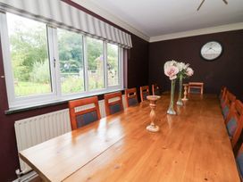 A dining room with a table and chairs at Tynewydd Fields in Cross Inn
