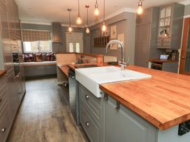 A kitchen with an island and sink at Tynewydd Fields in Cross Inn