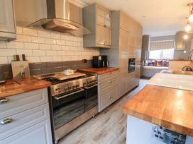 A kitchen with an oven and stovetop at Tynewydd Fields in Cross Inn