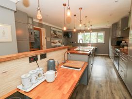 A kitchen with a central island and appliances at Tynewydd Fields in Cross Inn
