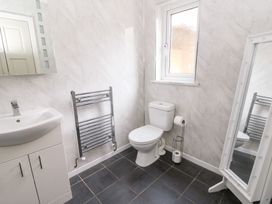 A bathroom with a sink toilet and towel rail at Tynewydd Fields in Cross Inn