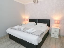 A bedroom with a bed and bedside tables at Tynewydd Fields in Cross Inn