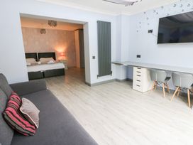 A living room with a sofa and desk at Tynewydd Fields in Cross Inn