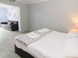 A bedroom with a bed and towels at Tynewydd Fields in Cross Inn