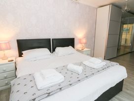 A bedroom with a bed and nightstand at Tynewydd Fields in Cross Inn