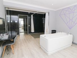 A bathroom with a bathtub and a shower at Tynewydd Fields in Cross Inn