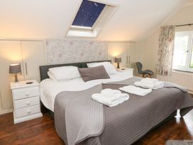 A bedroom with a double bed and nightstands at Tynewydd Fields in Cross Inn