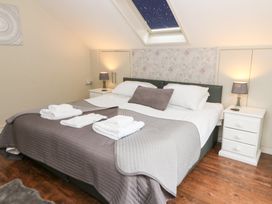 A bedroom with a bed and bedside tables at Tynewydd Fields in Cross Inn
