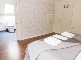 A bedroom with a bed and towels on top at Tynewydd Fields in Cross Inn