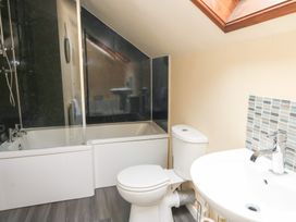 A bathroom with a bathtub, toilet and sink at Tynewydd Fields in Cross Inn