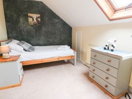 A bedroom with a single bed and a chest of drawers at Tynewydd Fields in Cross Inn