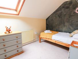 A bedroom with a bed and dresser at Tynewydd Fields Cross Inn