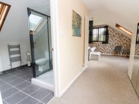 A bathroom with a shower and toilet at Tynewydd Fields in Cross Inn