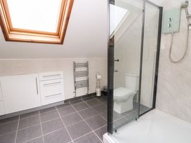 A bathroom with a shower and toilet at Tynewydd Fields in Cross Inn