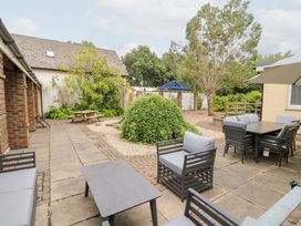 A garden with patio furniture and landscaping at Tynewydd Fields Cross Inn