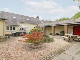 A garden with seating area and picnic table at Tynewydd Fields in Cross Inn
