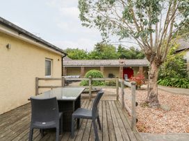 An outdoor seating area with a table and chairs at Tynewydd Fields in Cross Inn