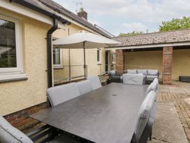 An outdoor dining area with a table and chairs at Tynewydd Fields in Cross Inn
