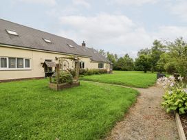 A house with a garden and pathway at Tynewydd Fields in Cross Inn
