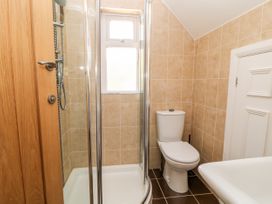 A bathroom with a shower enclosure a toilet and a sink at Harbour Lights in Torquay