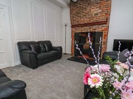 A living room with a sofa and a fireplace at The Anchorage in Whitby
