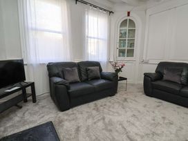 A living room with a sofa and television at The Anchorage in Whitby