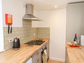 A kitchen with stove and cutting board at The Anchorage in Whitby