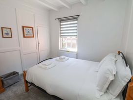 A bedroom with a bed and towels at The Anchorage in Whitby