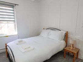 A bedroom with a bed and bedside table at The Anchorage in Whitby