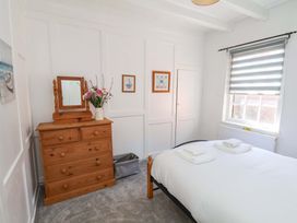 A bedroom with a bed and dressing table at The Anchorage in Whitby