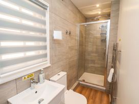 A bathroom with a shower, toilet and sink at The Anchorage in Whitby